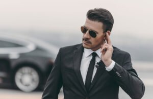 handsome bodyguard listening message with security UYEDKKW