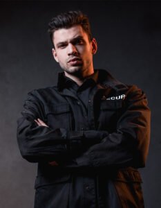 serious guard in uniform with crossed arms looking XZCE8Y7