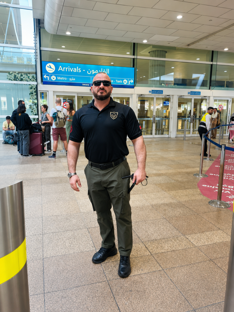 Professional close protection officer escorting VIP client through Dubai International Airport